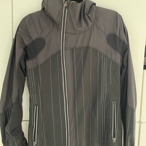 Lululemon waterproof jacket with hood & reflective detailing. exterior pockets.
